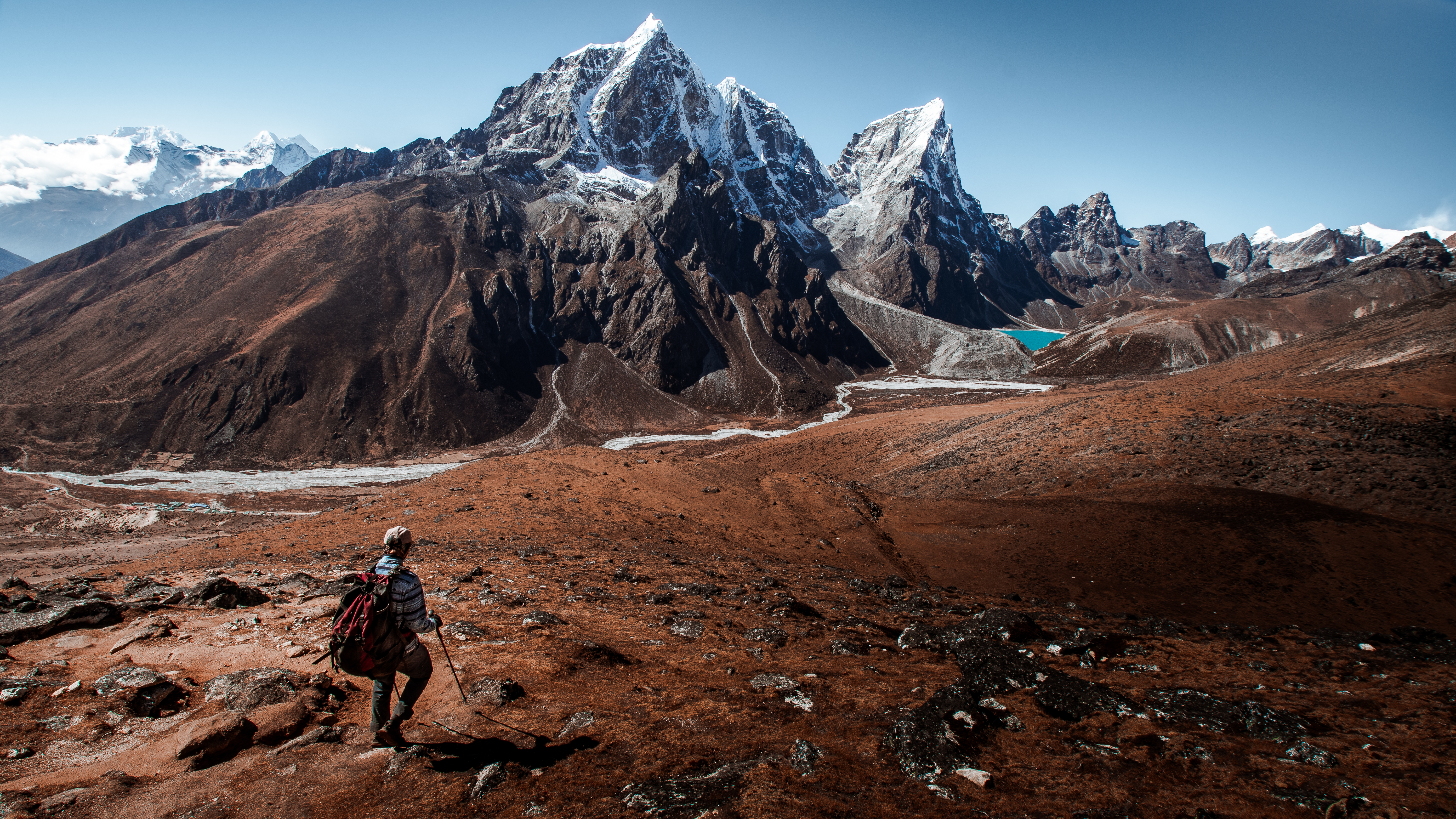 Person hiking in red sand mars-like mountains